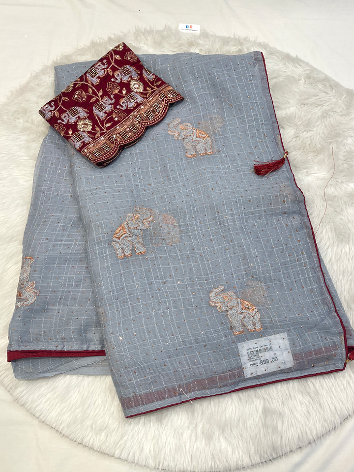 Light gray georgette saree with copper elephant embroidery and maroon velvet blouse