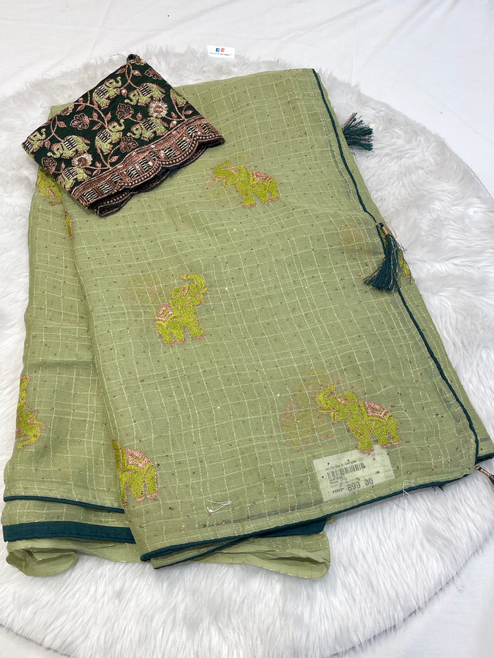 Light green georgette saree with bright elephant motifs and dark embroidered blouse