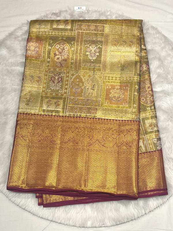 Kanjivaram Pattu saree with antique gold body, intricate Kalamkari block weaving, and wide contrast maroon Zari border.