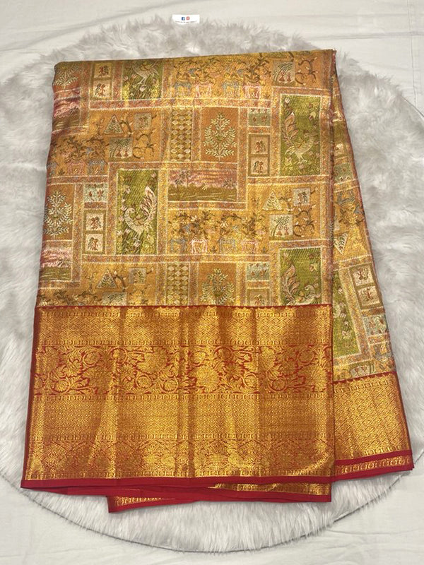 Opulent Antique Gold Kanjivaram Pattu Saree with all-over, multi-colored Kalamkari-style figurative and floral block weaving, featuring a wide, contrast Red Zari Brocade border.