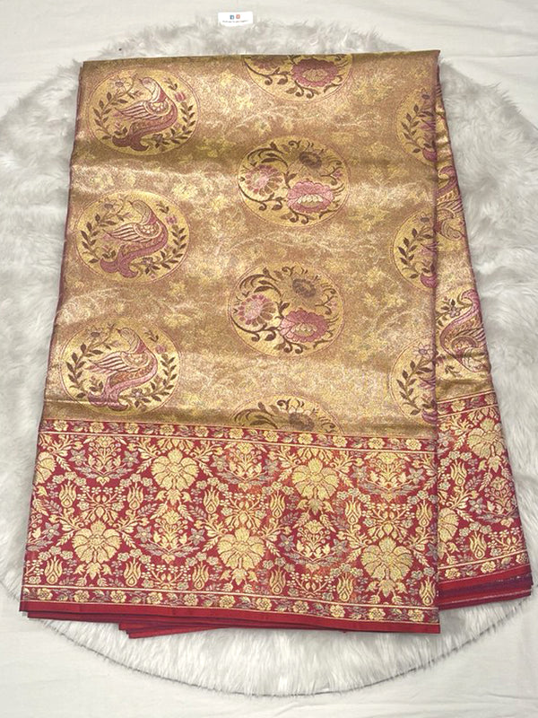 Opulent Gold Kanjivaram Pattu Saree featuring large, circular woven Chakra and peacock motifs in pink and gold Zari, set against an extra-wide, dense Contrast Red Zari Brocade border.