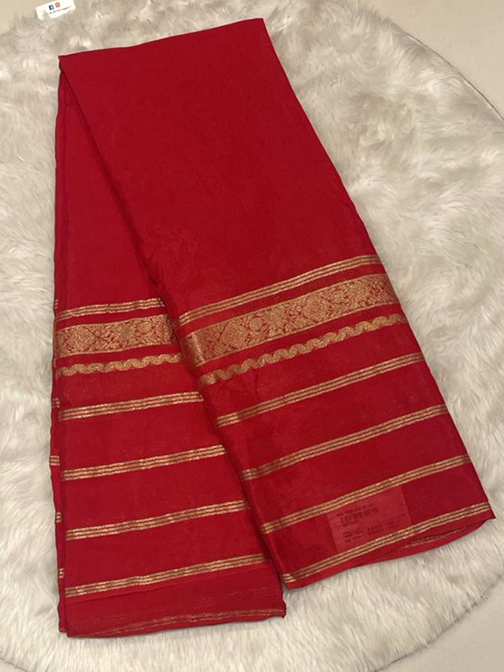 Bright red solid Banarasi crepe saree featuring zari stripes border for weddings
