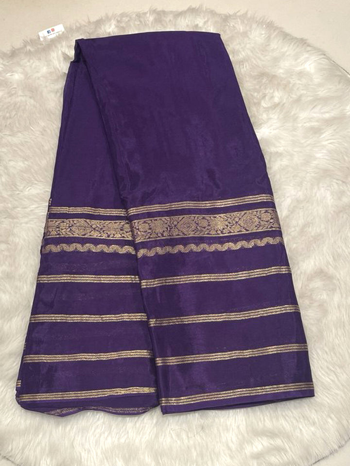Deep purple Banarasi crepe saree with plain body and gold zari stripe border design