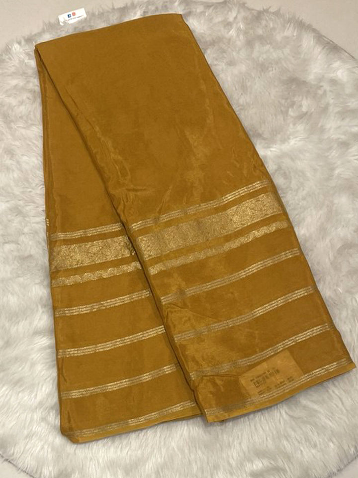 Mustard yellow plain Banarasi crepe saree with gold zari stripes border and self blouse