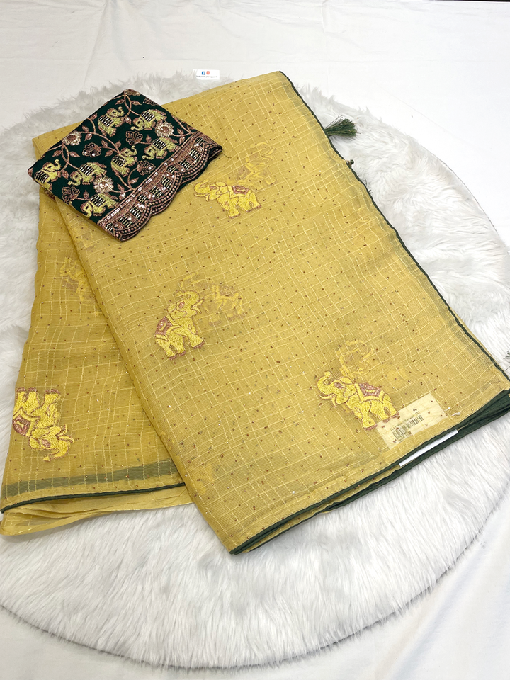 Mustard yellow georgette saree with bright yellow elephant motifs and dark green embroidered blouse