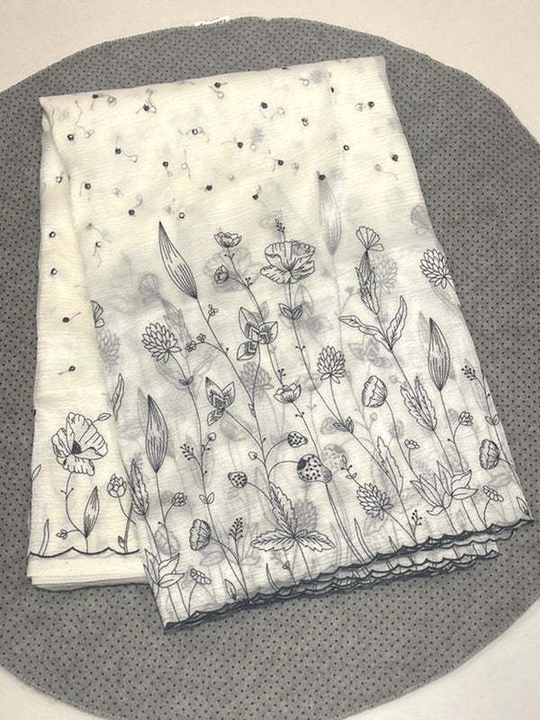 Off-white Jimmy Choo saree featuring contrast black floral embroidery and a scalloped cutwork border.