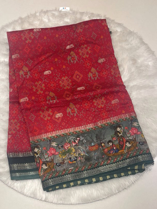 Red Mashru silk saree featuring geometric Ikkat patola pattern and a broad contrast dark green border with lotus and boat hand print design.