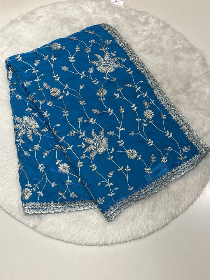 Cyan Blue Space Silk Saree with silver antique floral design and heavy cutwork border